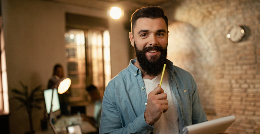 Checklist de meio de ano — empresário segurando tablet e caneta em escritório pronto para revisar obrigações antes de julho